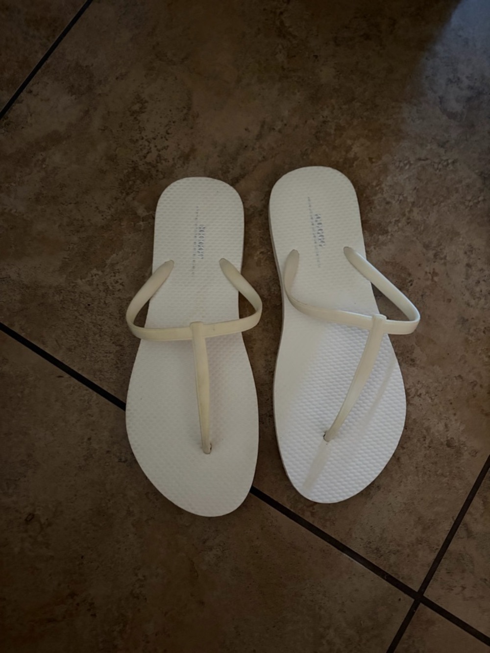 Women's Minimal T-strap Flip Flop Sandals in Off-White. Old Navy.